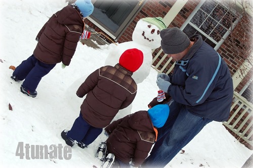 building a snowman with boys