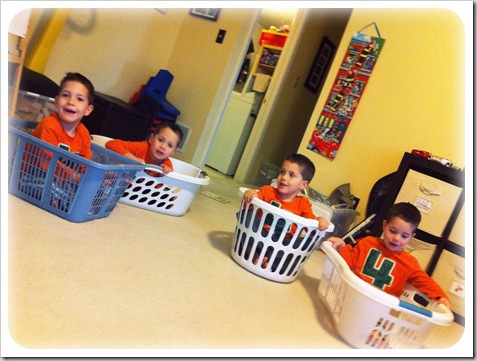 boys playing in laundry baskets