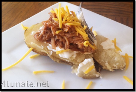 baked potatoes toped with bbq pulled pork sour cream and cheese