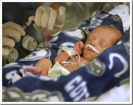 Jenny Heminger, RN (cq, hands) checks digestion on Brooks Layton Murray (cq) in the NICU at St. Vincent Women's Hospital, Friday, February 9, 2007.    Brooks was the second in a set of quadruplets born to Jen and Brad Murray last Friday, February 2, 2007.  He was 3 lbs at birth.    The four brothers are all in the NICU.  (Kelly Wilkinson / The Indianapolis Star)